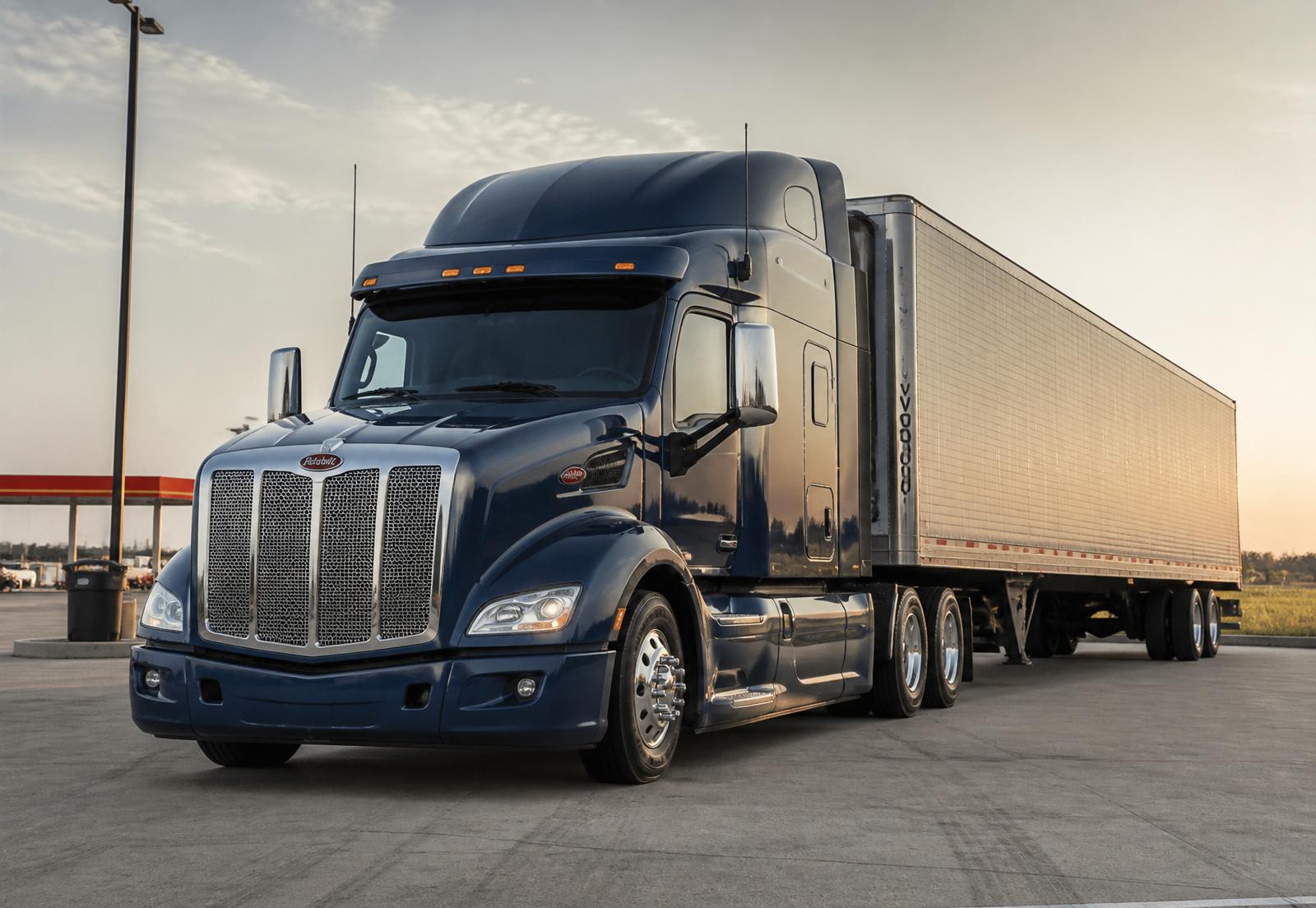 Deep navy blue Class 8 highway sleeper tractor with chrome accents at golden hour — the signature DATA Industries truck
